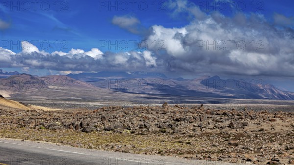 Rugged desert landscape with mountains and cloudy background in the distance, The highlands of the