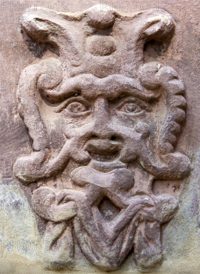 Old stone mask, face on a wall, Welf Castle of Herzberg, Herzberg am Harz, district of Göttingen,