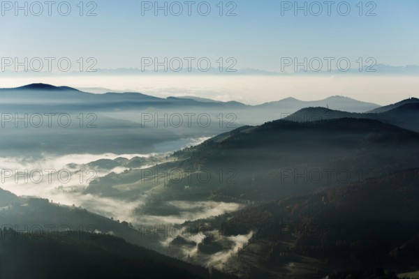 View from Belchen heading south of Wiesental and the Swiss Alps, morning atmosphere with fog in