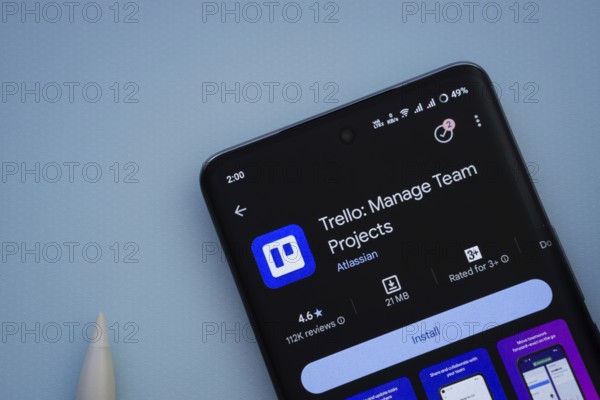 Dhaka, Bangladesh- 29 May 2025: On a blue surface, a smartphone displays the Trello app within the