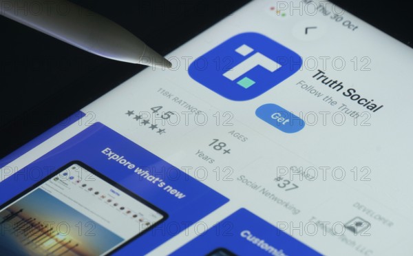 Dhaka, Bangladesh- 30 Oct 2025: Truth Social app on a iPad screen with a pen pointing at the
