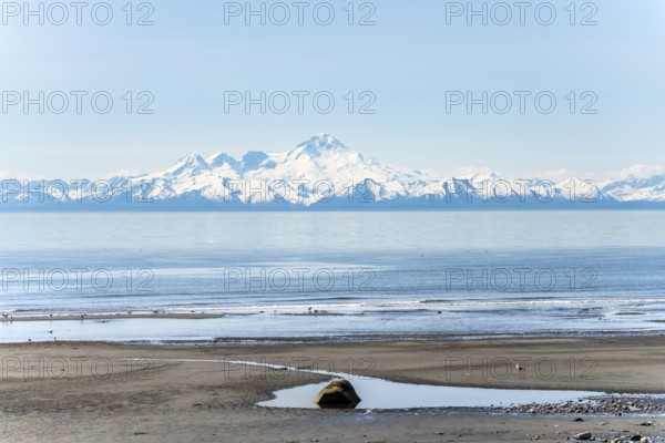 Beach at Anchor Point, Cook Inlet, glaciated mountain peaks of the Aleutian Range with Mount