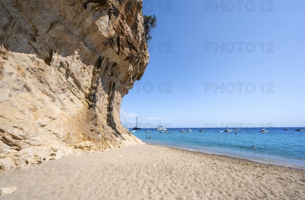 Sandy beach beach and steep cliffs at Cala Luna, Golfo di Orosei, Baunei, Sardinia, Italy