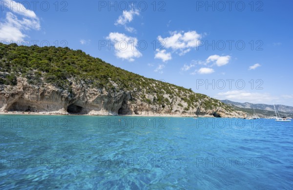 Clear blue water and picturesque rocky coast, Cala Luna cliffs and beach, Golfo di Orosei, Baunei,