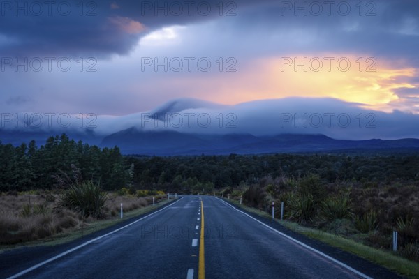 Mount Ngauruhoe in the morning at sunrise with glowing clouds, road SH 47. Tongariro National Park,