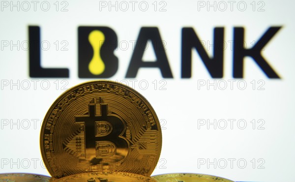 Dhaka, Bangladesh- 03 Sep 2025: Close-up of Bitcoin coins with the LBank logo visible on a screen