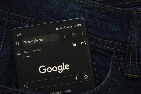 Dhaka, Bangladesh- 15 June 2025: A smartphone displaying the Google web interface peeks out of a