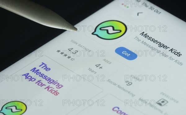 Dhaka, Bangladesh- 30 Oct 2025: Messenger Kids app on a iPad screen with a pen pointing at the