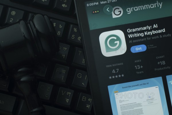Dhaka, Bangladesh- 28 Oct 2025: An iPad displaying the Grammarly app against a judge's gavel and