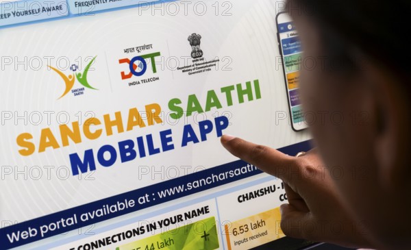 In this photo illustration, a person downloads the Sanchar Saathi mobile application on an iPhone,