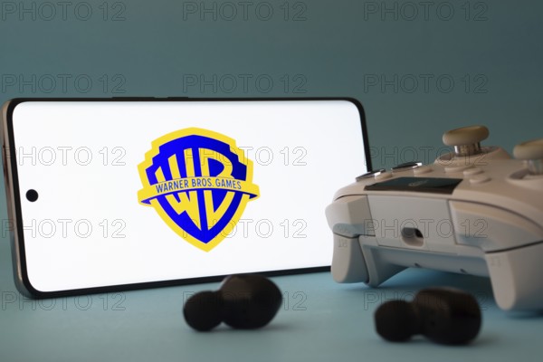 Dhaka, Bangladesh- 23 Mar 2025: A smartphone with a Warner Bros. Games icon next to a controller