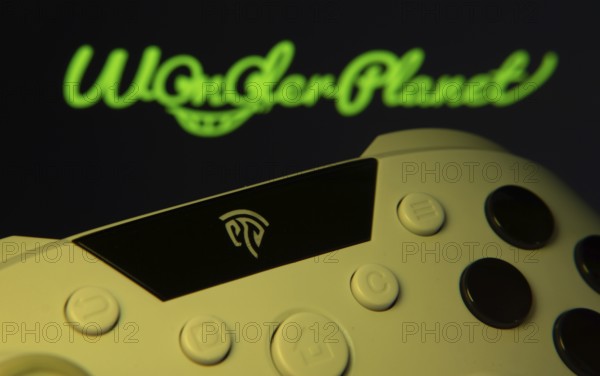 Dhaka, Bangladesh- 14 Nov 2025: A close-up of a gamepad with the WonderPlanet Inc seen on screen in