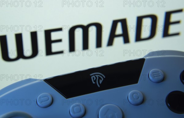 Dhaka, Bangladesh- 14 Nov 2025: A close-up of a gamepad with the WeMade Entertainment seen on