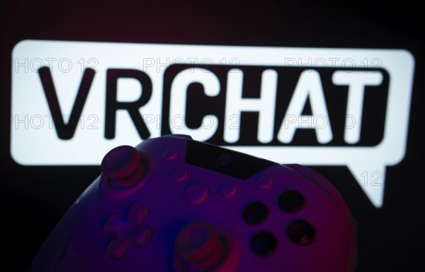 Dhaka, Bangladesh- 14 Nov 2025: A close-up of a gamepad with the VRChat seen on screen in the