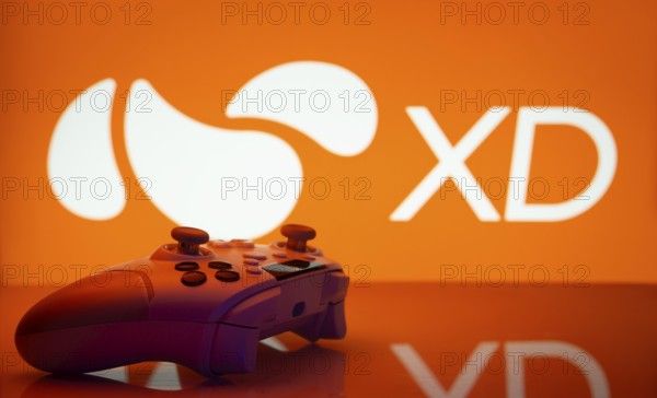 Dhaka, Bangladesh- 14 Nov 2025: A close-up of a white gamepad with the XD seen on screen in the