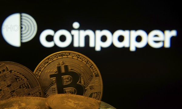 Dhaka, Bangladesh- 19 Sep 2025: Close-up of Bitcoin coins with the Coinpaper logo visible on a