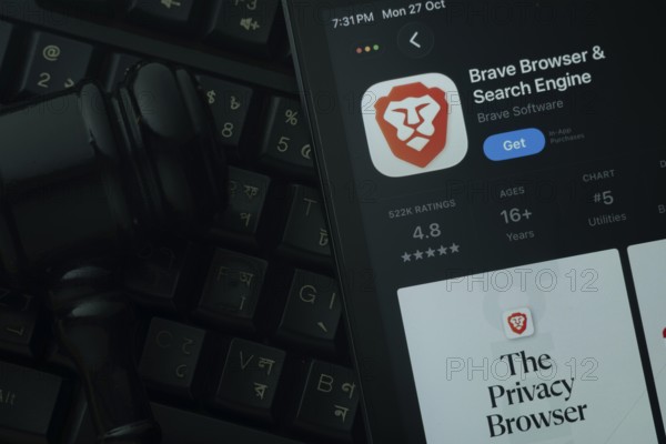 Dhaka, Bangladesh- 28 Oct 2025: An iPad displaying the Brave browser app against a judge's gavel
