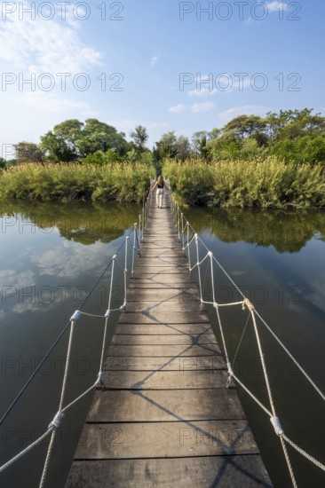 Toruist on the Kavango River, suspension bridge at Camp Kwando, Zambezi region, Caprivi Strip,