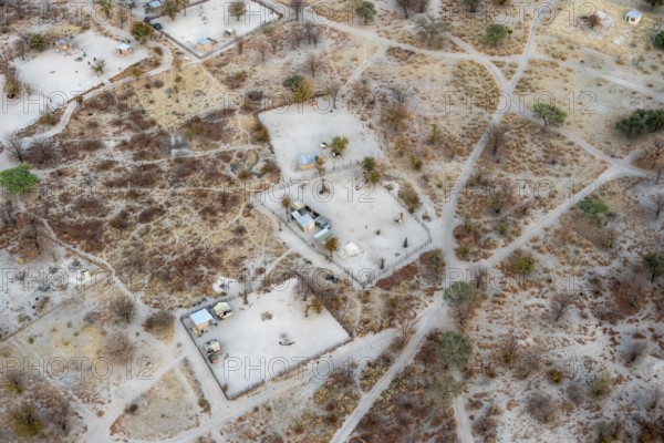 Settlement, simple house and fence, dry savanna landscape, near Maun, aerial view, Okavango Delta,