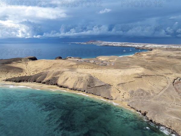 Coast with Playa Caleta del Congrio beach and blue sea, arid landscape of Los Ajaches Natural Park,