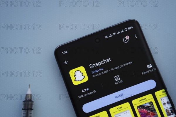 Dhaka, Bangladesh- 29 May 2025: On a blue surface, a smartphone displays the Snapchat app within