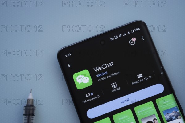 Dhaka, Bangladesh- 29 May 2025: On a blue surface, a smartphone displays the wechat app within the