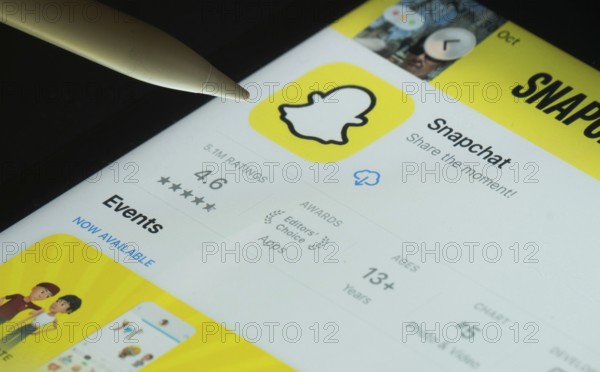 Dhaka, Bangladesh- 30 Oct 2025: Snapchat app on a iPad screen with a pen pointing at the install