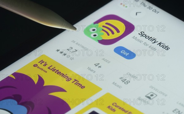 Dhaka, Bangladesh- 30 Oct 2025: Spotify Kids app on a iPad screen with a pen pointing at the