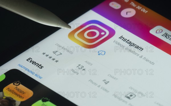 Dhaka, Bangladesh- 30 Oct 2025: Instagram app on a iPad screen with a pen pointing at the install