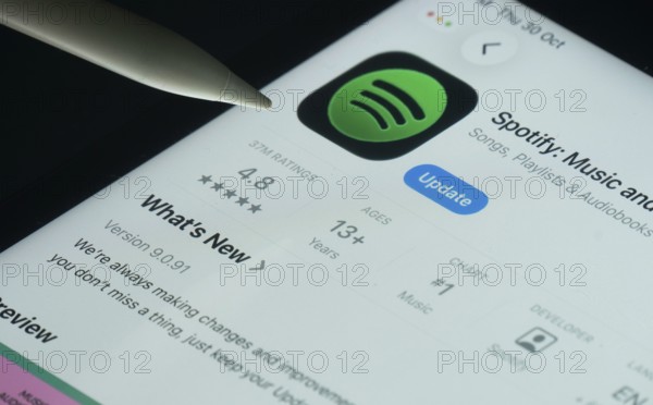 Dhaka, Bangladesh- 30 Oct 2025: Spotify app on a iPad screen with a pen pointing at the install