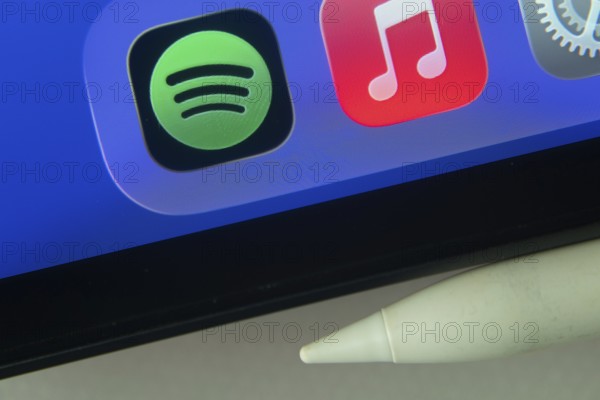 16 Nov 2025- Dhaka, Bangladesh: Spotify and Apple Music and other app icons with a digital pen on a