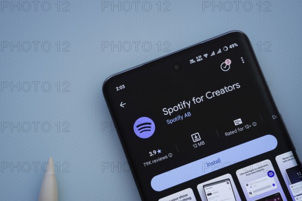 Dhaka, Bangladesh- 29 May 2025: On a blue surface, a smartphone displays the Spotify for Creators