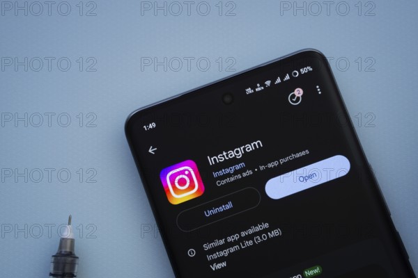 Dhaka, Bangladesh- 29 May 2025: On a blue surface, a smartphone displays the Instagram app within
