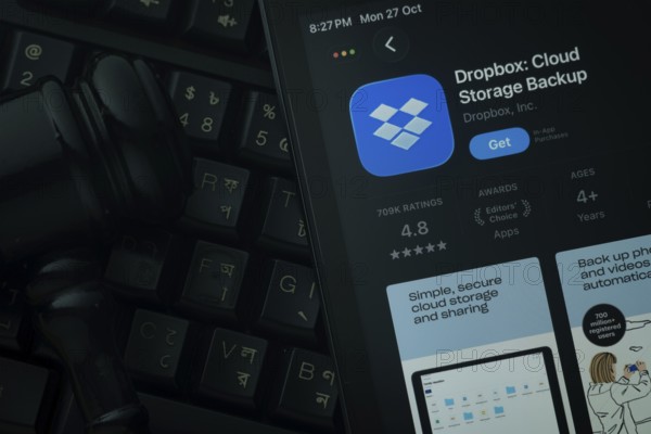Dhaka, Bangladesh- 28 Oct 2025: An iPad displaying the Dropbox app against a judge's gavel and dark