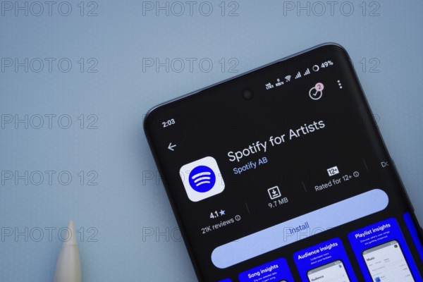 Dhaka, Bangladesh- 29 May 2025: On a blue surface, a smartphone displays the Spotify for Artists