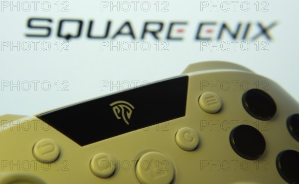 Dhaka, Bangladesh- 14 Nov 2025: A close-up of a gamepad with the Square Enix seen on screen in the
