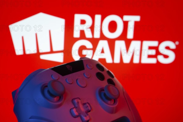 Dhaka, Bangladesh- 14 Nov 2025: A close-up of a gamepad with the Riot Games seen on screen in the