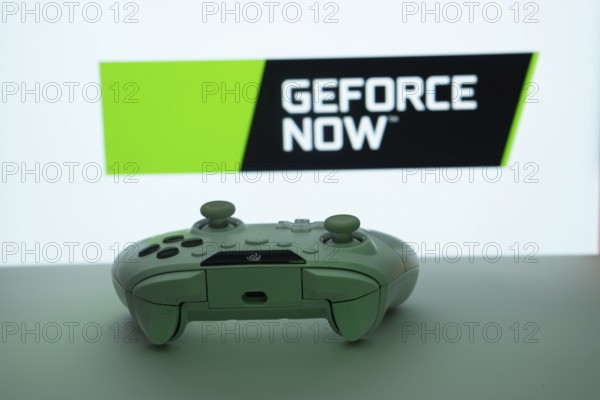 Dhaka, Bangladesh- 14 Nov 2025: A close-up of a white gamepad with the Geforce Now seen on screen