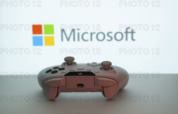 Dhaka, Bangladesh- 09 May 2025: A close-up of a white gamepad with the Microsoft seen on screen in