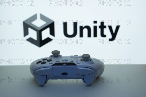 Dhaka, Bangladesh- 14 Nov 2025: A close-up of a white gamepad with the Unity seen on screen in the