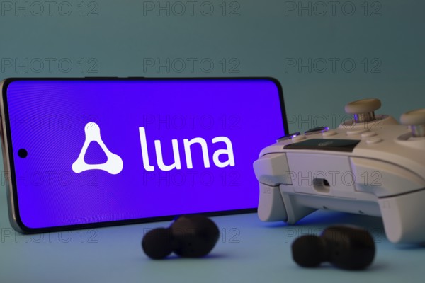 Dhaka, Bangladesh- 23 Mar 2025: A smartphone with a Amazon Luna icon next to a controller and