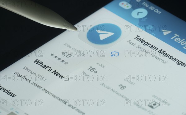 Dhaka, Bangladesh- 30 Oct 2025: Telegram app on a iPad screen with a pen pointing at the install