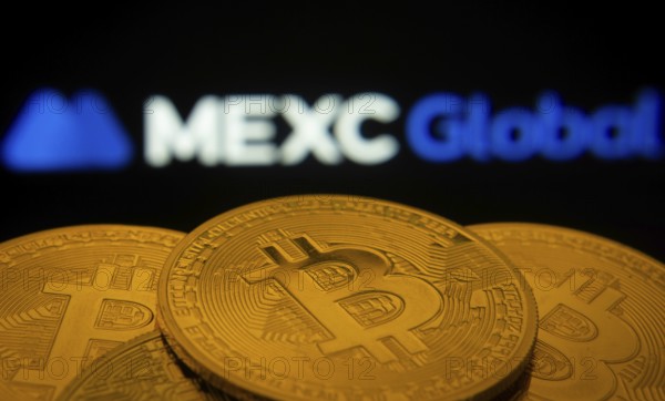 Dhaka, Bangladesh- 03 Sep 2025: Close-up of Bitcoin coins with the MEXC Global logo visible on a