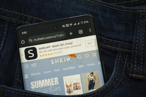 Dhaka, Bangladesh- 15 June 2025: A smartphone displaying the SHEIN web interface peeks out of a
