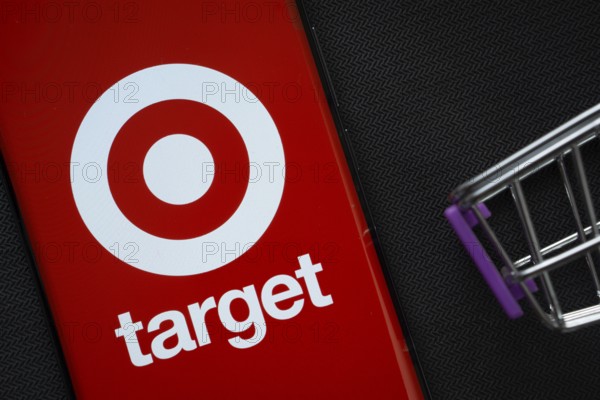Dhaka, Bangladesh- 03 July 2025: A smartphone displaying the Target logo next to a miniature