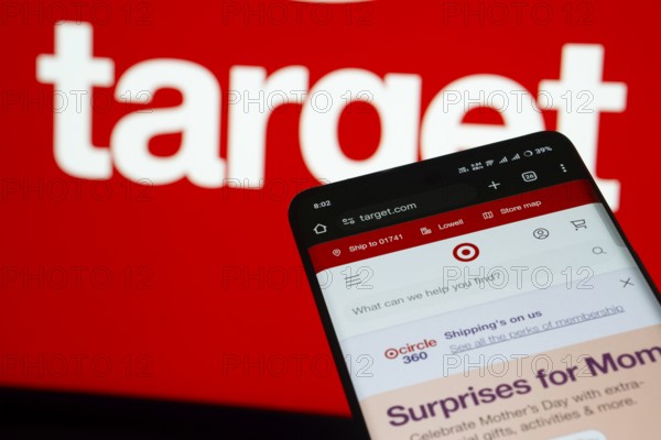 Dhaka, Bangladesh- 03 July 2025: Smartphone displaying Target web interface against Target logo