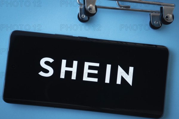 Dhaka, Bangladesh- 03 July 2025: Smartphone screen showing the SHEIN logo with shopping cart wheels