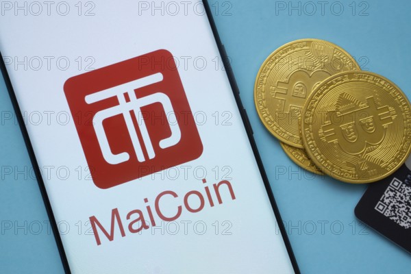 Dhaka, Bangladesh- 03 Sep 2025: MaiCoin logo on smartphone screen near Bitcoin coin and QR code on