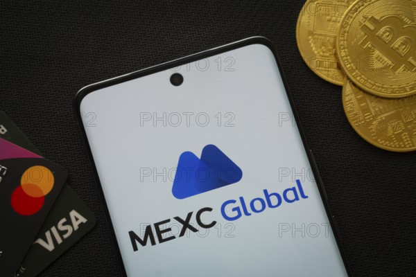 Dhaka, Bangladesh- 06 Sep 2025: Smartphone displaying MEXC Global logo surrounded by Bitcoin coins