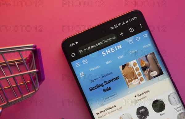 Dhaka, Bangladesh- 23 June 2025: A smartphone displaying the SHEIN website with a shopping cart is